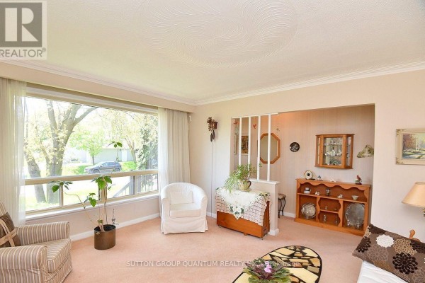 Living room with large window, display cabinet, and partition screen - 499 Valley Drive N Oakville