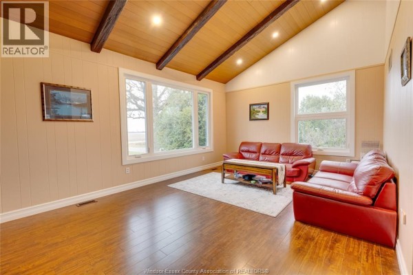 Spacious dining room with tile flooring, large table for eight, and natural light from nearby windows. - 4996 Badder Line, Merlin