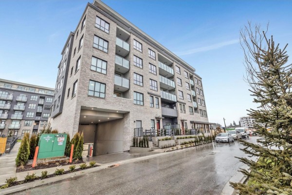 Exterior of a modern brick apartment building with multiple balconies and underground parking. - 4f 15738 85 Avenue, Surrey