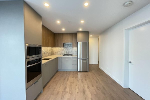 Kitchen with grey and wood cabinets, stainless steel appliances, and marble-look backsplash. - 4xx 13359 Old Yale Rd, Surrey