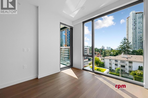 Empty room with large windows and city view. - 4xx 5987 Wilson Avenue, Burnaby
