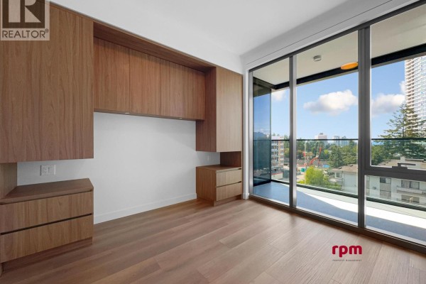 Room with built-in wood cabinets and balcony access with city view. - 4xx 5987 Wilson Avenue, Burnaby