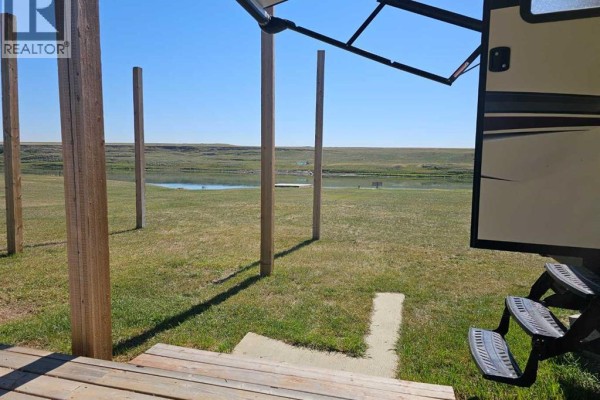 View from RV steps overlooking grassy land and distant water feature. - 5, 172039 Hwy 539, Bow City