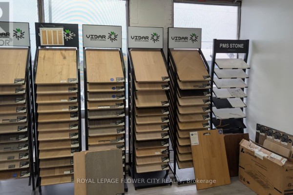 Close-up view of flooring samples on display racks, including wood and stone textures. - 5,6 - 1201 Franklin Boulevard, Cambridge