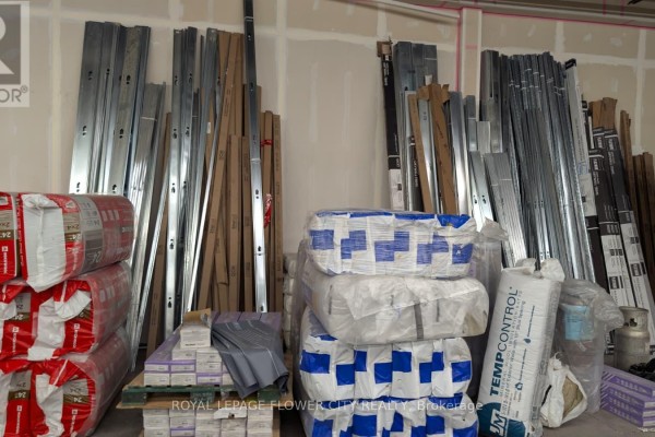 Storage area showing stacks of insulation, metal framing, wood, and other construction supplies. - 5,6 - 1201 Franklin Boulevard, Cambridge
