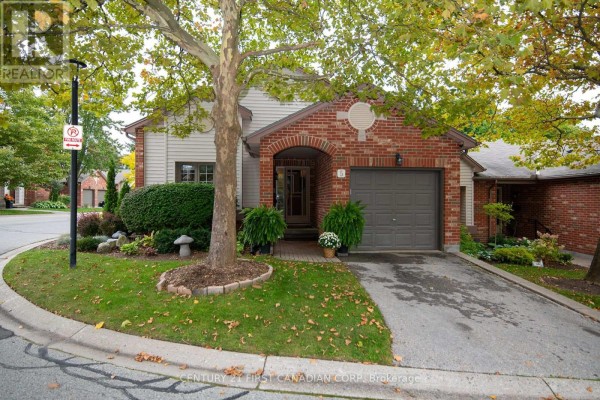 Front exterior view of a townhouse with a green lawn and mature tree. - 5 - 1100 Byron Baseline Road, London South