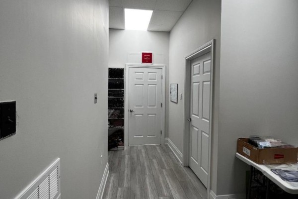 Hallway with a mirror reflecting multiple doorways, showing an optical illusion. - 5 - 2645 Liruma Road, Mississauga
