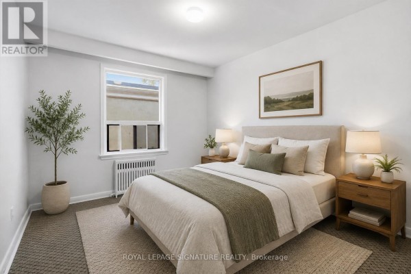 Bedroom with bed, nightstands, dresser, plant, and window. - 5 - 46 Albert Avenue, Toronto