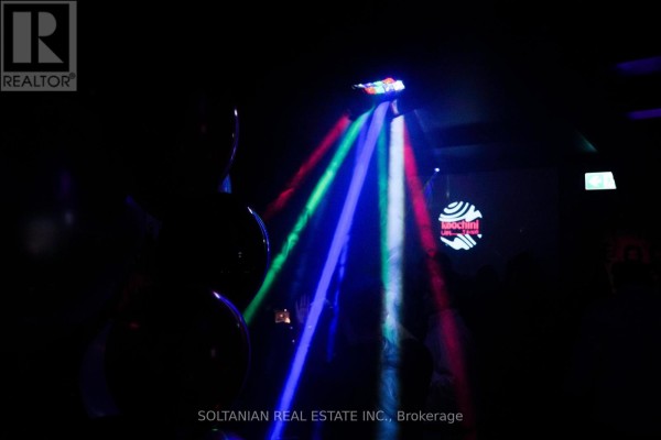 Nightclub interior with laser lights, people at tables, and a bar area with balloons. - 5 - 5 Glen Cameron Road, Markham