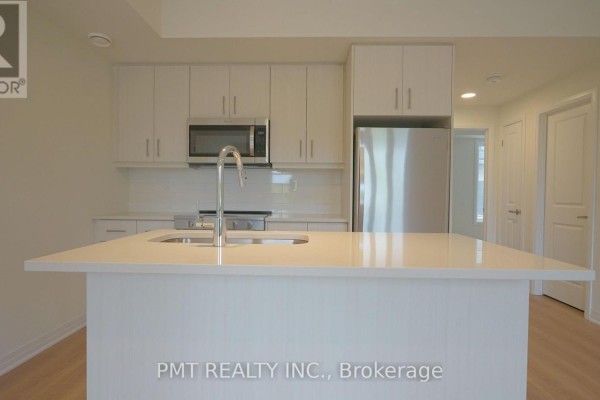 Close-up of the kitchen island with a stainless steel faucet. - 5 - 737 Front Royal Street, Mississauga