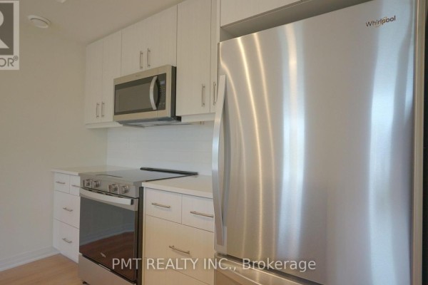 Stainless steel refrigerator and stove in a modern white kitchen. - 5 - 737 Front Royal Street, Mississauga