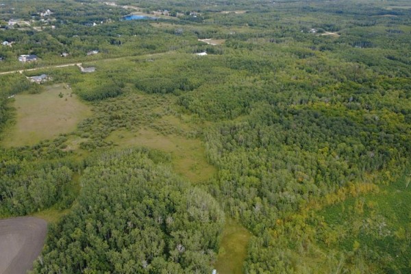 Aerial view of undeveloped land with trees and fields under a cloudy sky. - 5 44 N Road, Ste Anne Rm