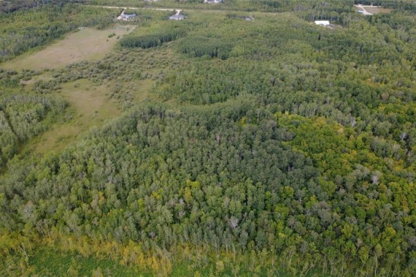 Aerial view showing a large area of dense trees and some cleared fields. - 5 44 N Road, Ste Anne Rm
