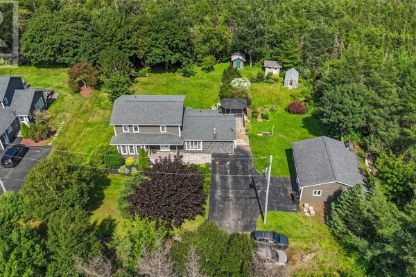 Aerial view of the residential property showing the main house, garage, sheds, and surrounding trees. - 5-7 Spelling Hill Road, Burin Bay Arm