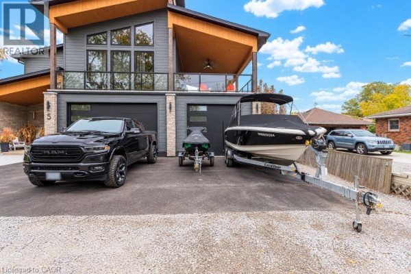 Close-up of modern house driveway with boat, jet ski, and truck parked. - 5 Archibald Drive, Port Rowan