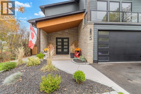 Front entrance of modern house with double doors, stone accents, and landscaping. - 5 Archibald Drive, Port Rowan