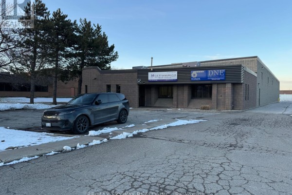 Front view of commercial building with parked vehicle and snow-covered landscape - 5 Automatic Road, Brampton