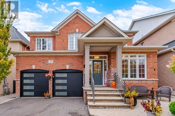 Front exterior view of a two-story brick house with a covered porch and double garage doors. - 5 Billancourt Crescent, Brampton