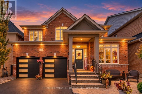 Front facade of a brick house illuminated at dusk with a colorful sunset sky overhead. - 5 Billancourt Crescent, Brampton