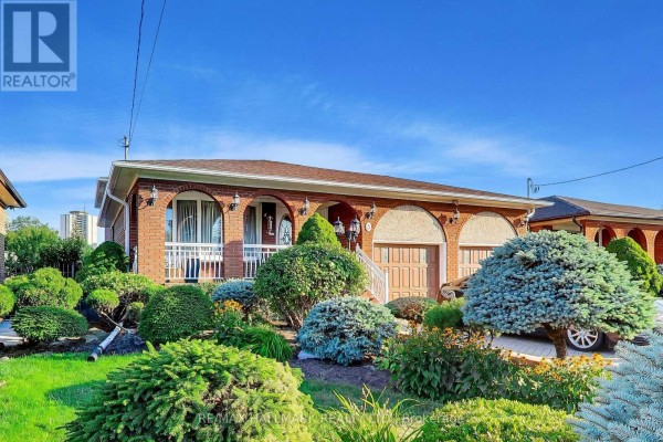 Front view of a brick bungalow with manicured shrubs and flower beds. - 5 Byworth Boulevard, Toronto