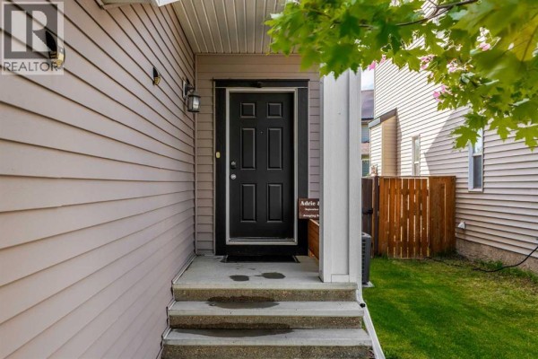 Interior entryway with a black door, shoe rack, coat rack, and a window. - 5 Copperpond Link Se, Calgary