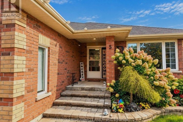 View of the front entrance and porch of a brick bungalow. - 5 Denfield Road, Kawartha Lakes