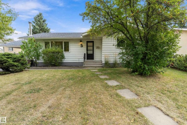 Front view of the white bungalow with a paved walkway leading to the front door. - 5 Glenbrook Bv, Sherwood Park