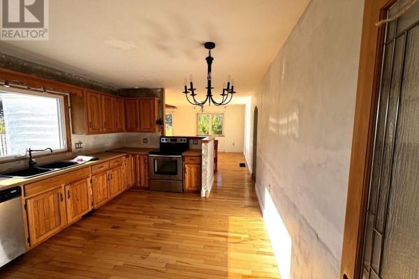 Kitchen and dining area with light wood cabinets, hardwood floors, and a view through to windows. - 5 Homestead Road, Bayswater
