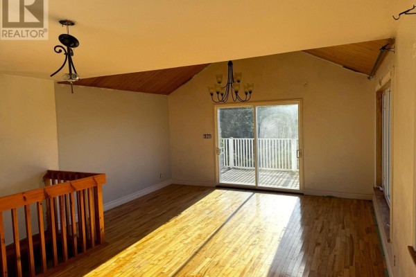 Room with hardwood floors, wooden ceiling, sliding glass doors to a deck, and large windows. - 5 Homestead Road, Bayswater