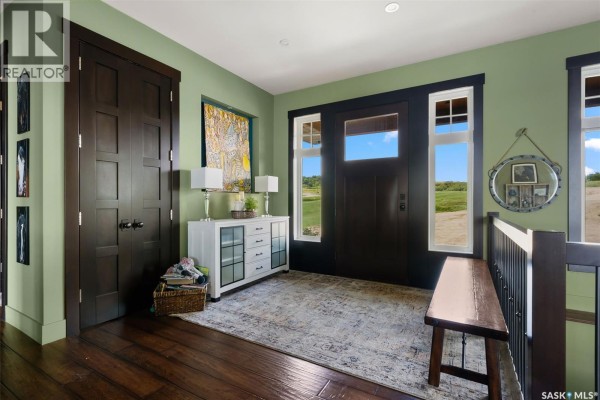 Entryway featuring green walls, large windows, a bench, and a decorative rug. - 5 Kiiswa Point, Mckillop Rm No  220
