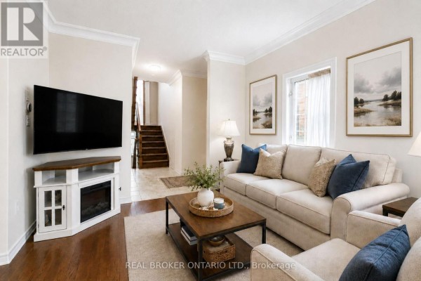 Living room with leather sofa, armchairs, chandelier, and hardwood flooring - 5 Liddycoat Lane, Hamilton