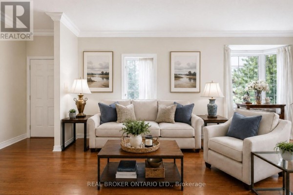 Cozy living area with leather couch, decorative armchair, and natural light from windows - 5 Liddycoat Lane, Hamilton