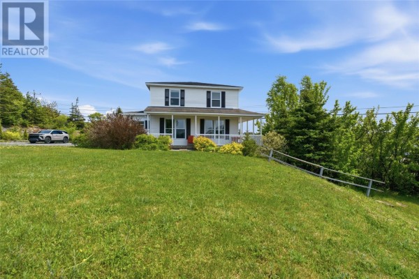 Front view of a white two-story house with a large green lawn and trees. - 5 Main Street, Little Bay