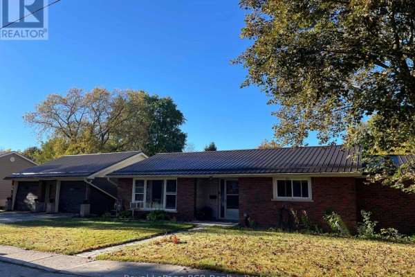Front view of a single-story brick house with a dark metal roof and attached garage. - 5 Stinson Street, South Bruce