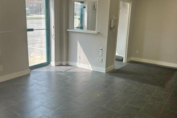 Interior view of a commercial space with tiled floor, glass door, and reception counter. - 5 To 8 - 112 Saunders Road, Barrie