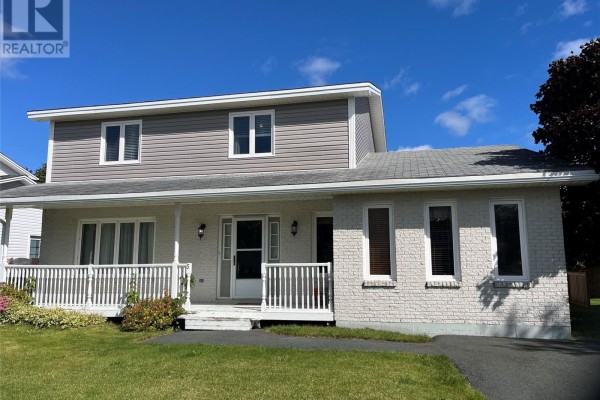 Two-story home with light brick and grey siding, white porch and trim. - 5 Trafalgar Drive, Mount Pearl