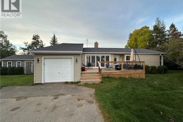The back of the bungalow features a wooden deck, multiple windows, and sliding glass doors. - 5 Valleyview Drive, Wards Creek