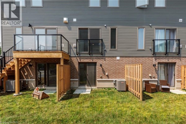 Street view of a townhouse complex showing units 32 and 34 with garages. - 5 Winters Crescent, Collingwood