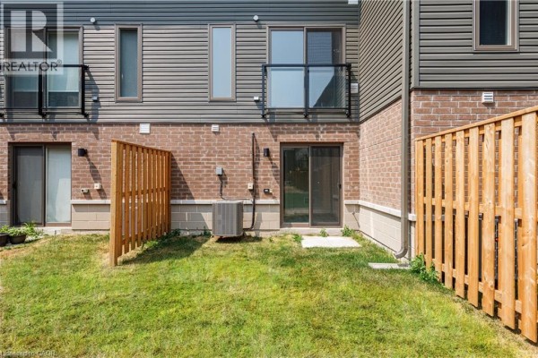 Exterior of townhouses with a white Audi parked in front of unit 7. - 5 Winters Crescent, Collingwood