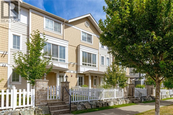 Exterior view of beige and grey townhouse units with white picket fences. - 50 370 Latoria Blvd, Colwood