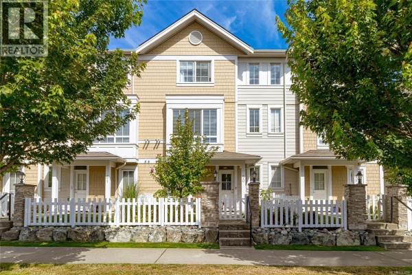 Front facade of multi-story townhouses with beige siding and white trim. - 50 370 Latoria Blvd, Colwood