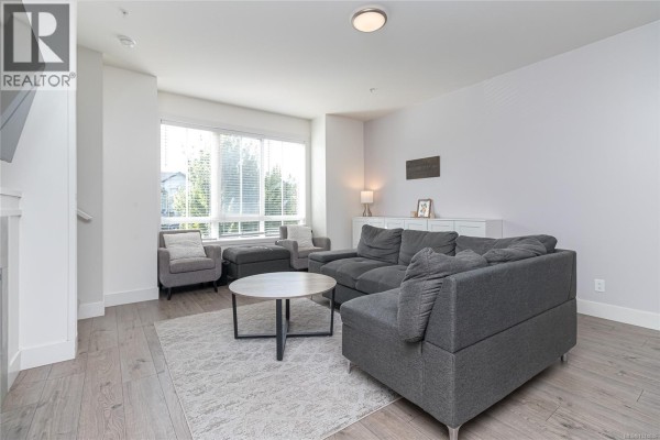 Living room with a large sectional sofa, coffee table, and big window. - 50 370 Latoria Blvd, Colwood