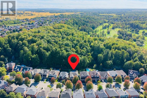 Aerial view of a residential street with houses and a golf course in the background. - 50 Arborglen Drive, Halton Hills