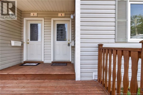 Two light grey apartment doors, numbered 5 and 6, with glass panels and wooden steps. - 50 Damien Street Unit# 6, Dieppe