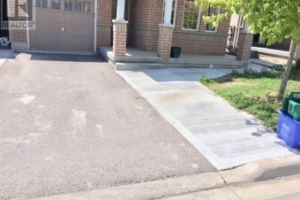 Driveway with a concrete ramp leading to the covered porch of a brick house. - 50 Geddington Crescent, Markham