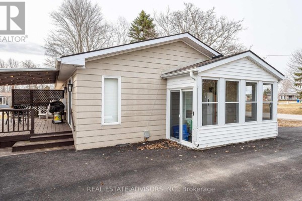 Grey single-story home with ramp access, flagpole, and flower planters - 50 Juno Crescent Georgina