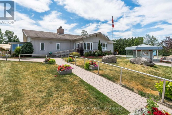 Swimming pool with lounge chairs and striped awning - 50 Juno Crescent Georgina