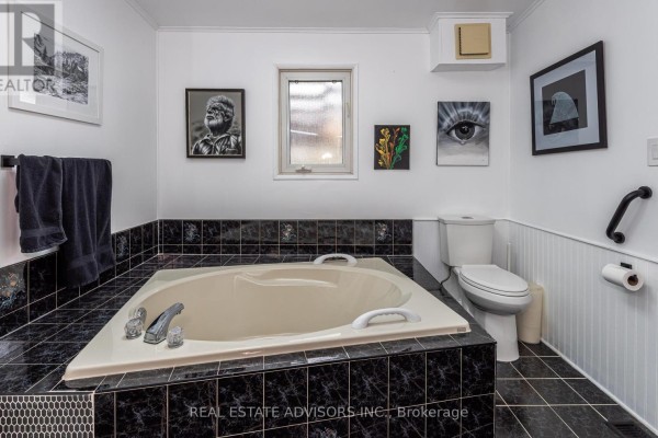 Soaking tub and double vanity bathroom with black tile accents - 50 Juno Crescent Georgina