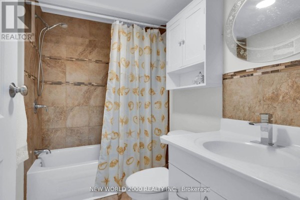 Bathroom with bathtub, shower, toilet, vanity, sink, medicine cabinet, mirror, and seashell shower curtain - 50 Livingstone Street W Barrie