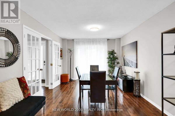 Dining room with dark wood table, leather chairs, French doors, hardwood floors, mirror - 50 Livingstone Street W Barrie